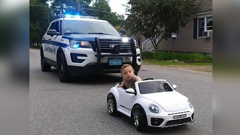 Adorable photo shows Lowell police officer stopping toddler hanging out of toy  car - Boston News, Weather, Sports