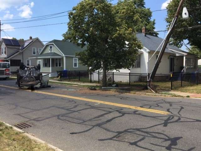 Driver hospitalized after striking utility pole, flipping car - Boston ...