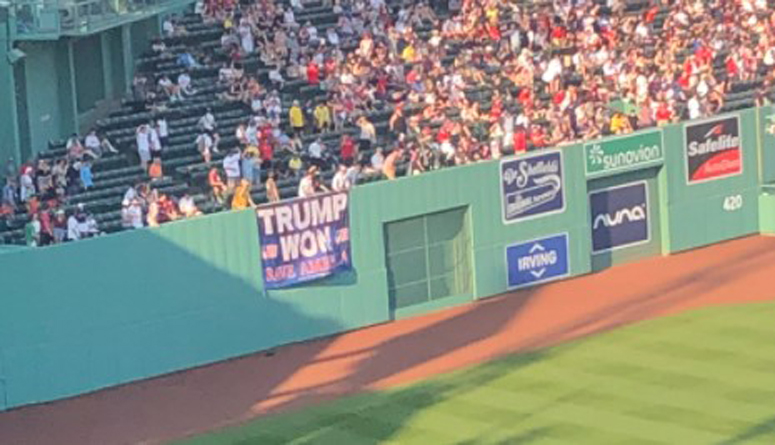 A photograph of some red and blue banners outside Fenway Park in