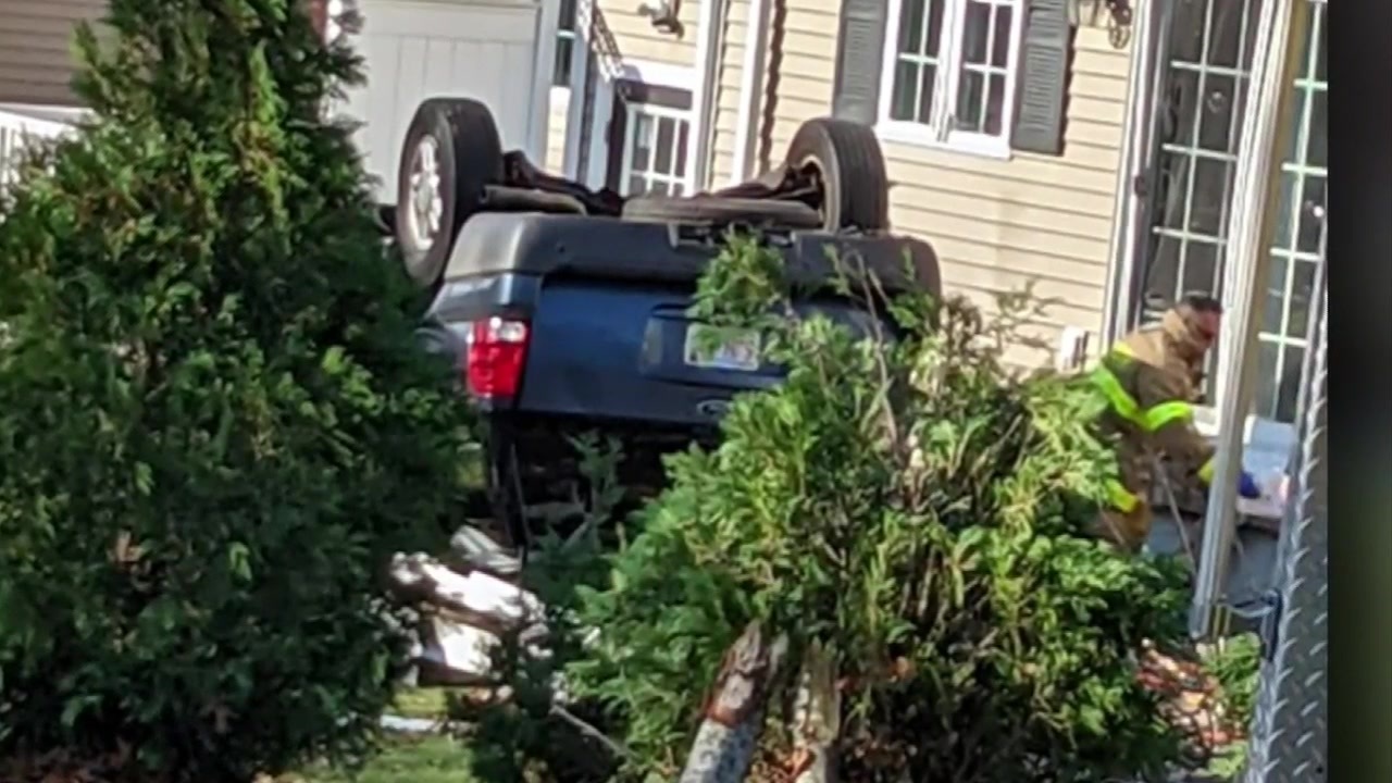 Investigation underway after car flips over, leaves gaping hole in