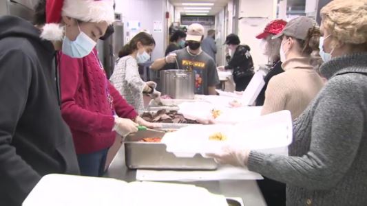 Father-son duo, dozens of volunteers cook up more than 1,000 Christmas Day meals for those in need in Malden