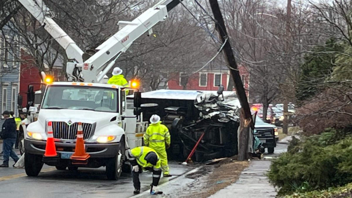 Driver ejected, left pinned under truck after crashing into pole in