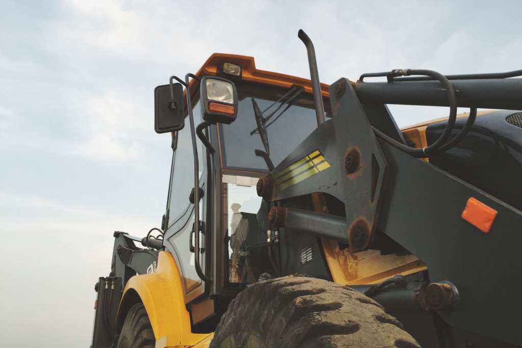 yellow and black heavy equipment under blue sky