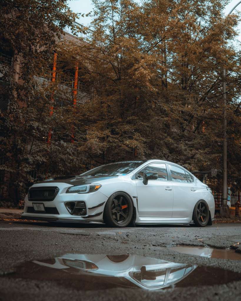 white subaru car parked on street side