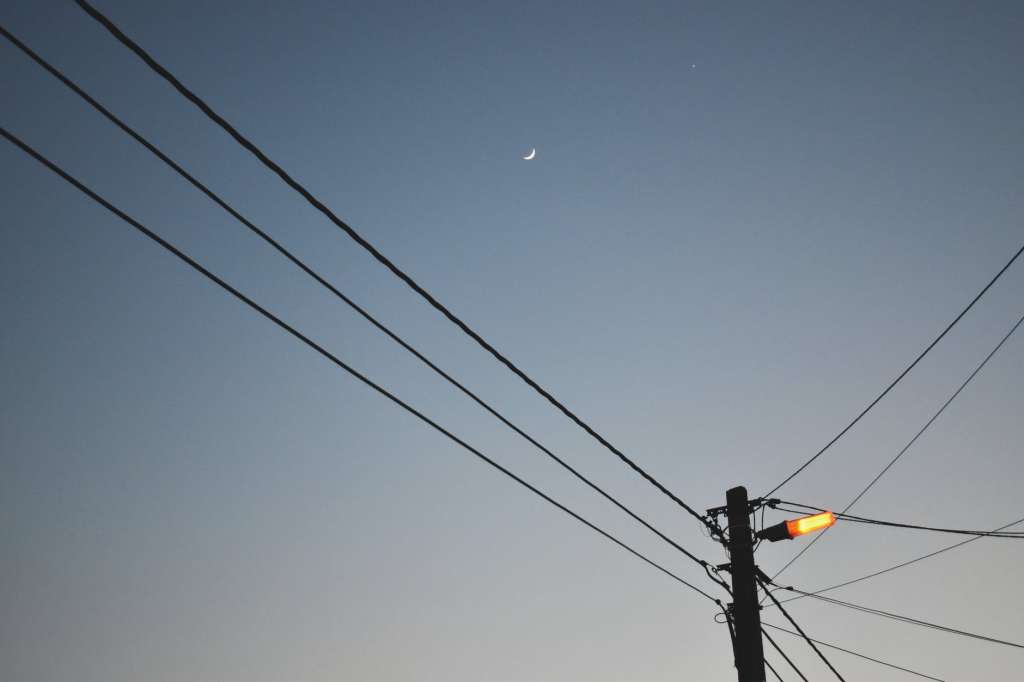 orang light on utility pole under the sky