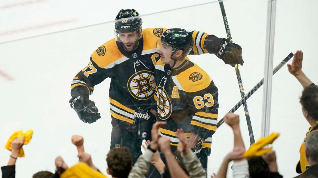 Boston Bruins' Charlie McAvoy, right, celebrates his goal against