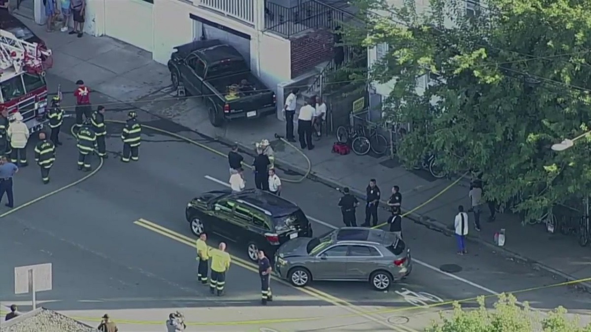Truck pins a woman after crashing into garage in Chelsea Boston News