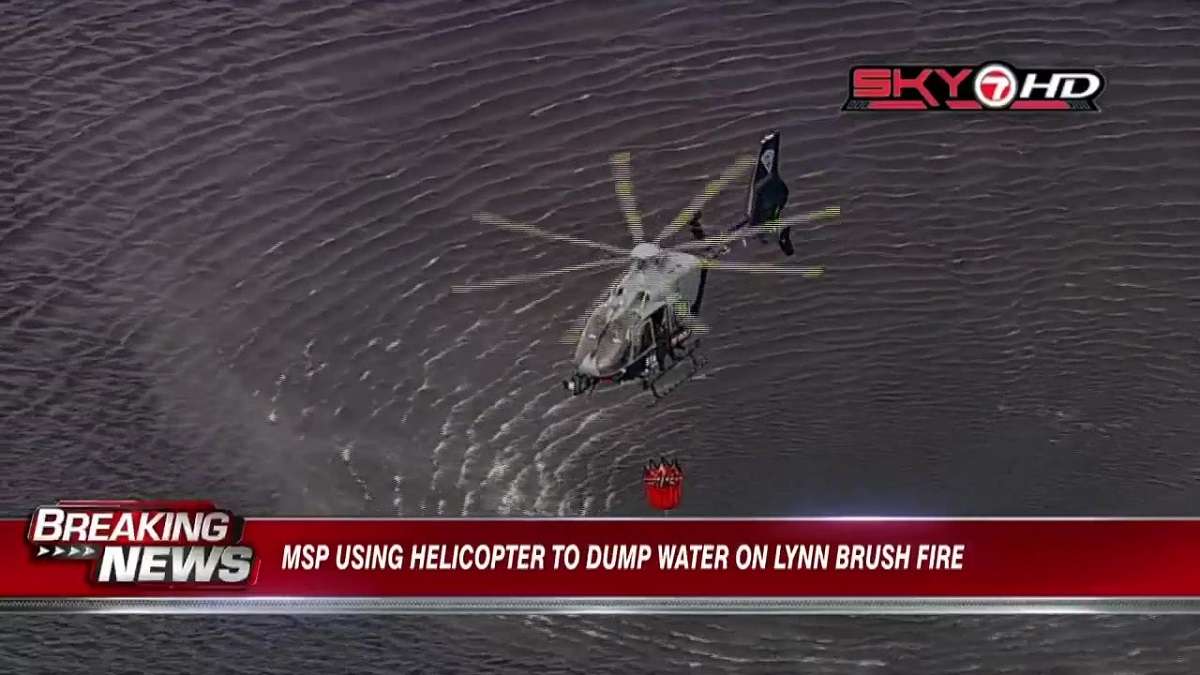WATCH: Crews use helicopter to dump water on Lynn brush fire - Boston ...