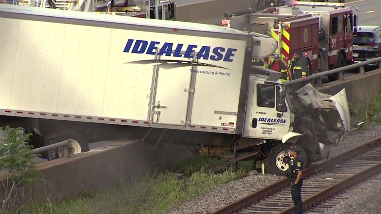 Multi-vehicle crash on Mass Pike sends truck onto Boston train tracks ...