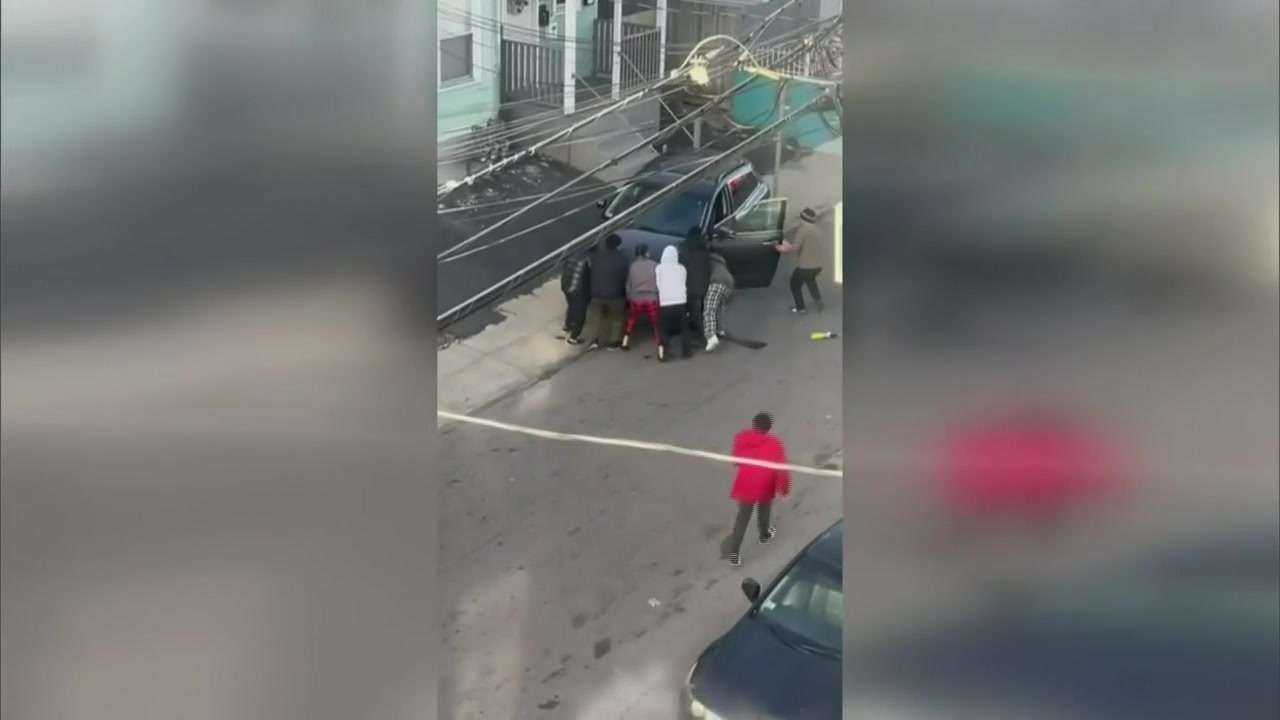 Residents spring into action to help lift car off woman trapped ...