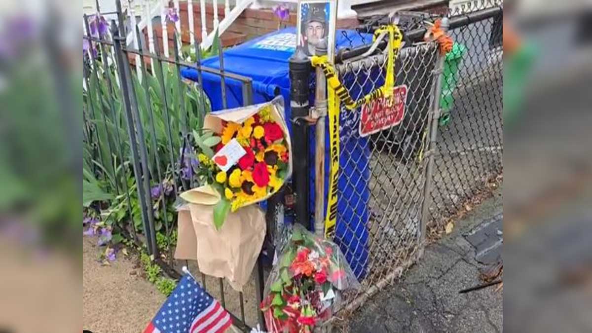 Community placing flowers, flags at growing memorial to fallen firefighter in Dorchester